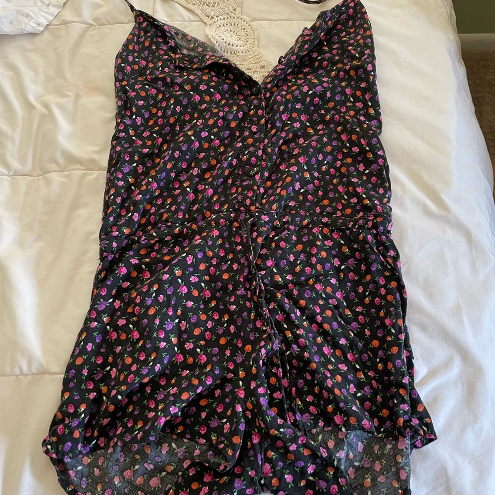 Button-up romper with little rose pattern and a sweater material laced back.